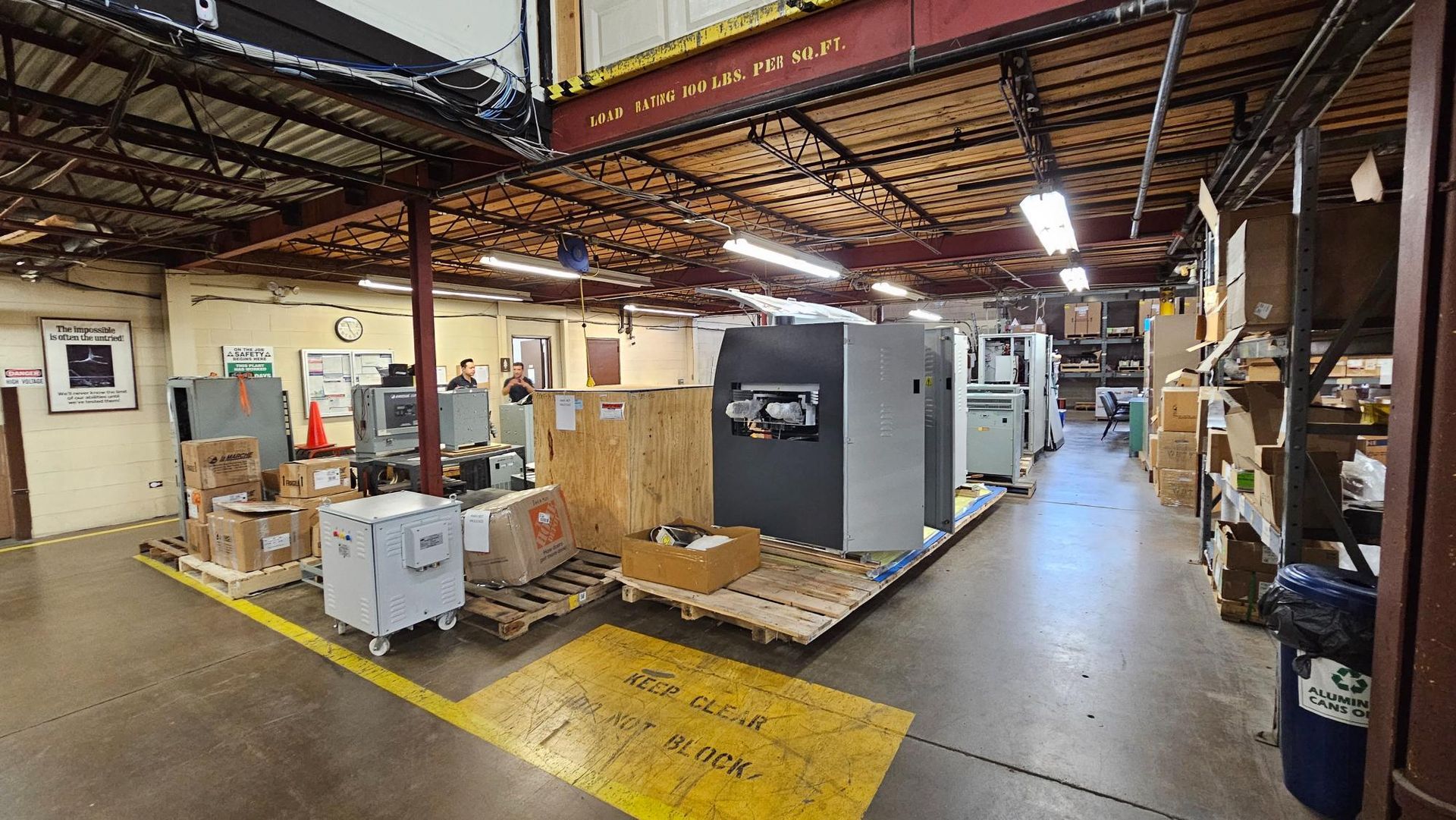 A large warehouse filled with lots of boxes and machinery.