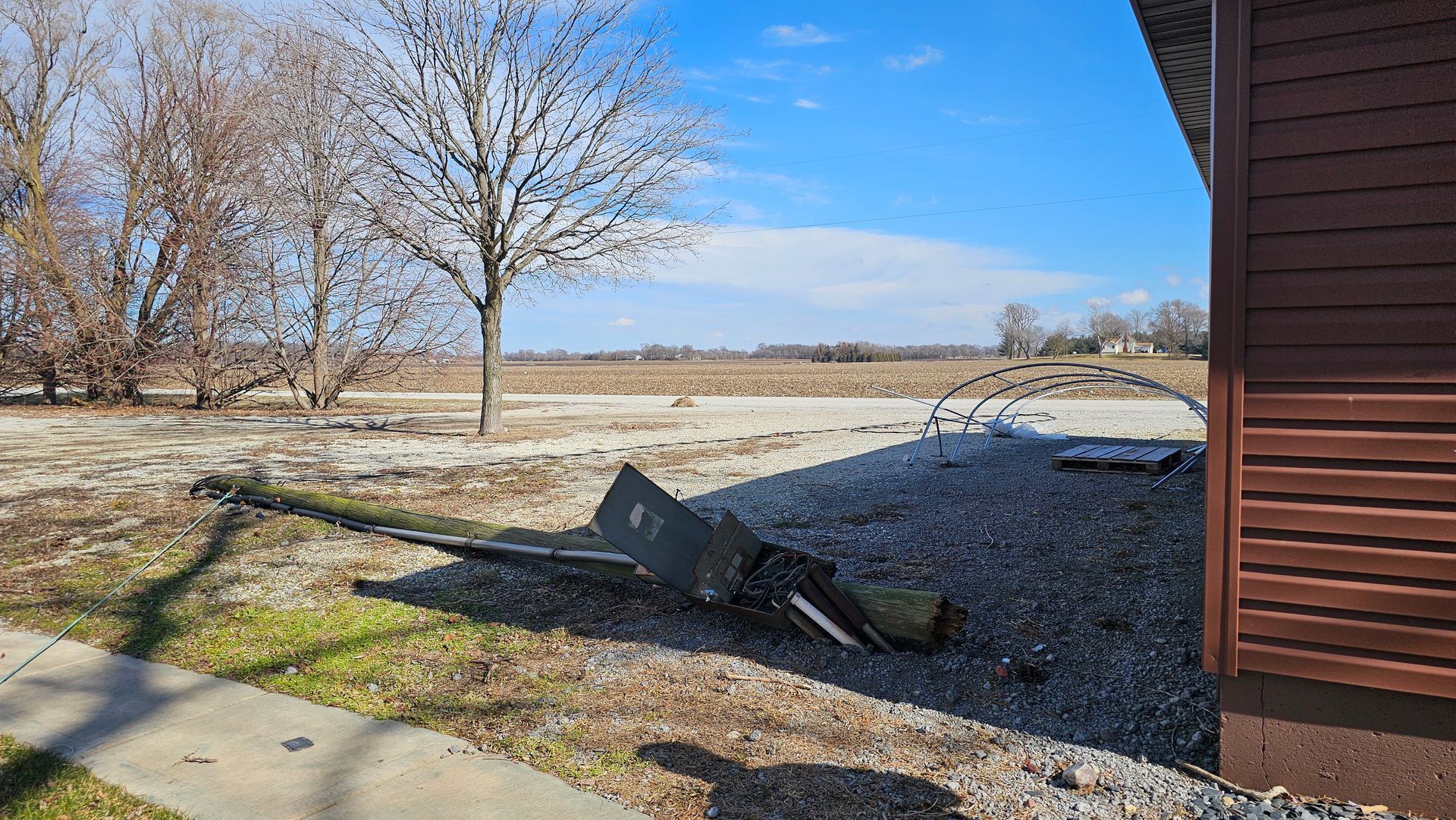 A piece of metal is laying on the ground in front of a house.
