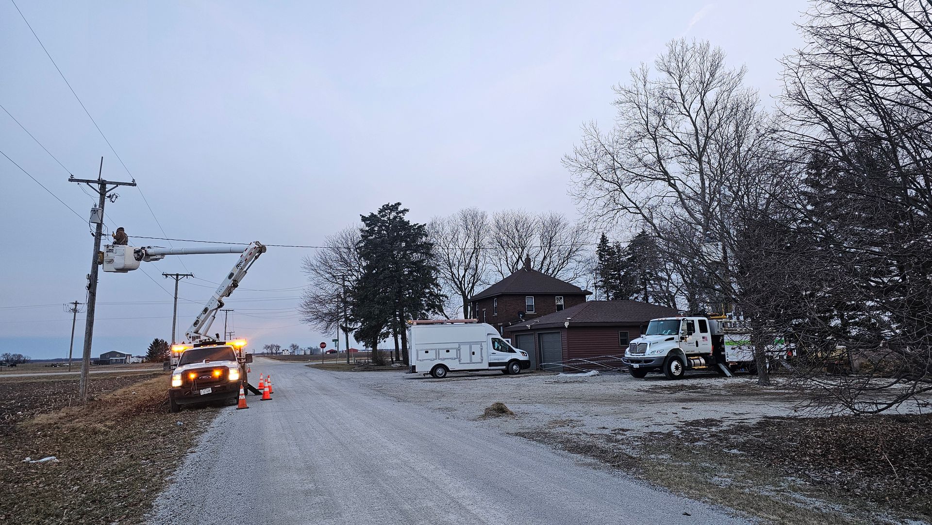 A white van is parked on the side of the road in front of a house.