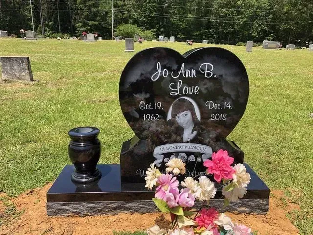 A Heart-shaped Gravestone in a Cemetery with Flowers and a Vase – Canton, MS – Davidson Marble & Granite