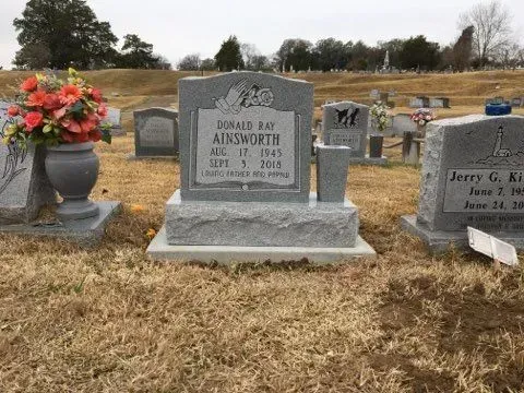 A Gravestone in a Cemetery with Flowers in a Vase – Canton, MS – Davidson Marble & Granite