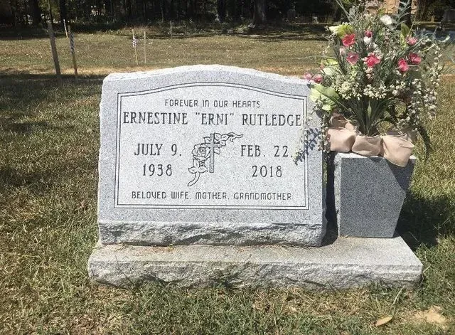 A Gravestone with Flowers on it in a Cemetery – Canton, MS – Davidson Marble & Granite