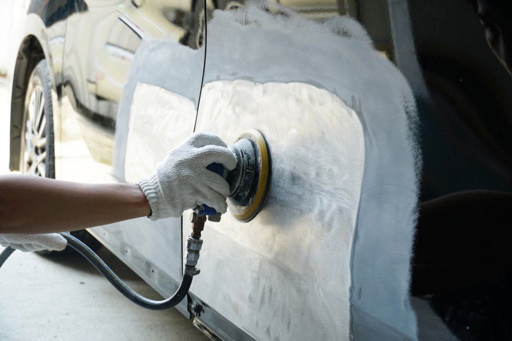 Person Sanding Car Door With a Power Sander — Mid City Smash Repairs in Dubbo, NSW