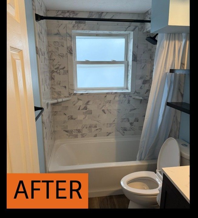 Newly renovated bathroom featuring a white bathtub, marble-patterned tile, and a window with frosted glass.