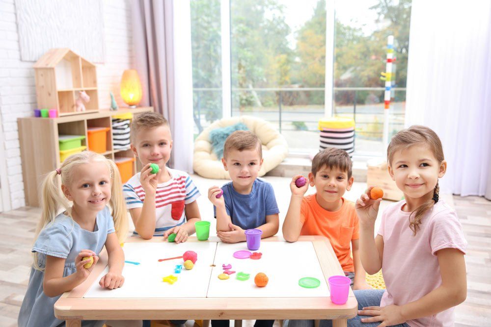 Little Children Engaged In Playdough Modeling At Daycare — Grandma Rosie’s Quality Long Day Care In Wollongong, NSW