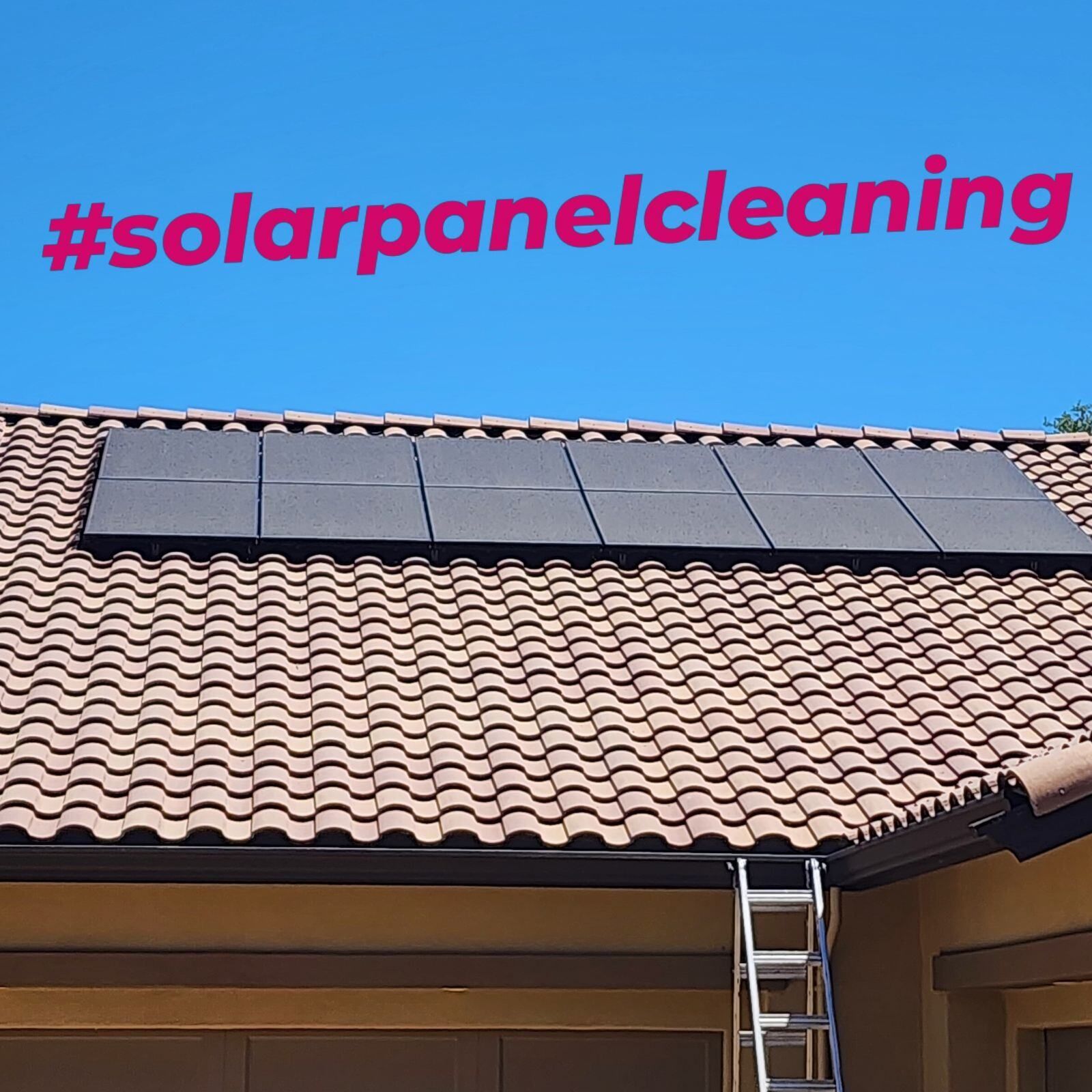 Solar panels on a tiled roof with a ladder.  The hashtag #solarpanelcleaning is overlaid on a blue sky.