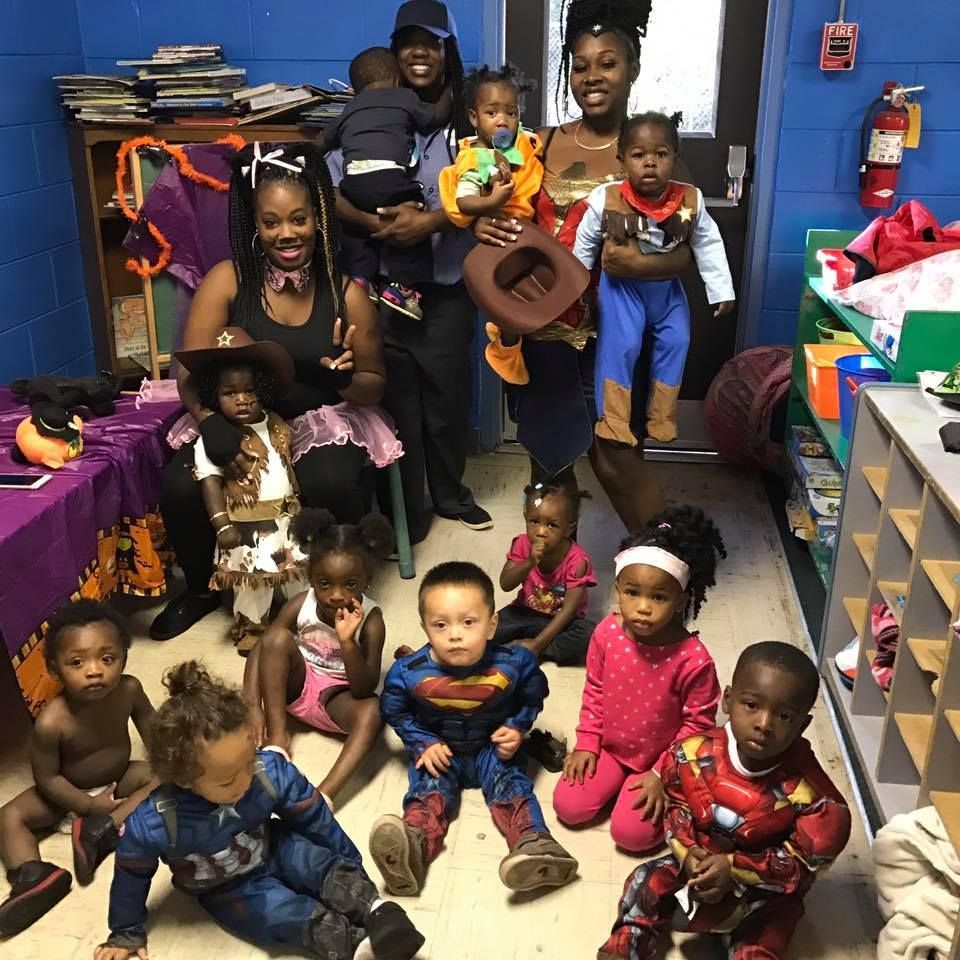 A group of children in costumes are posing for a picture