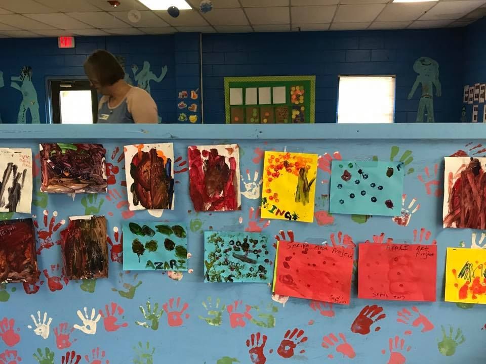 A wall with a lot of hand prints on it