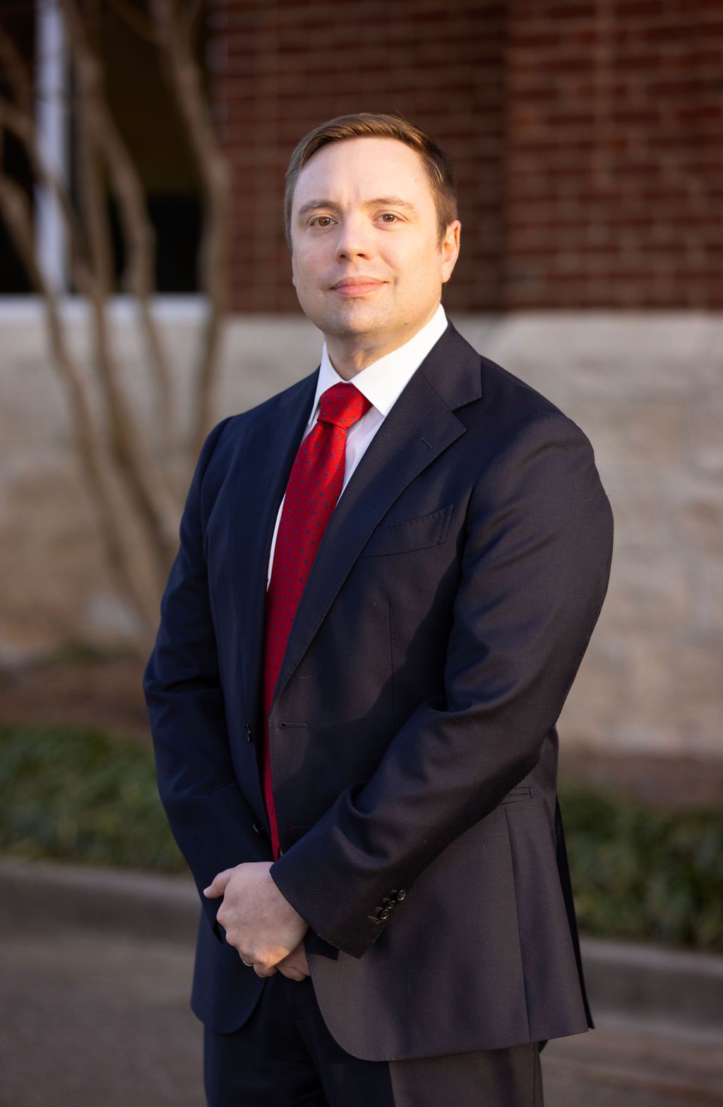 A man in a suit and tie is smiling for the camera.