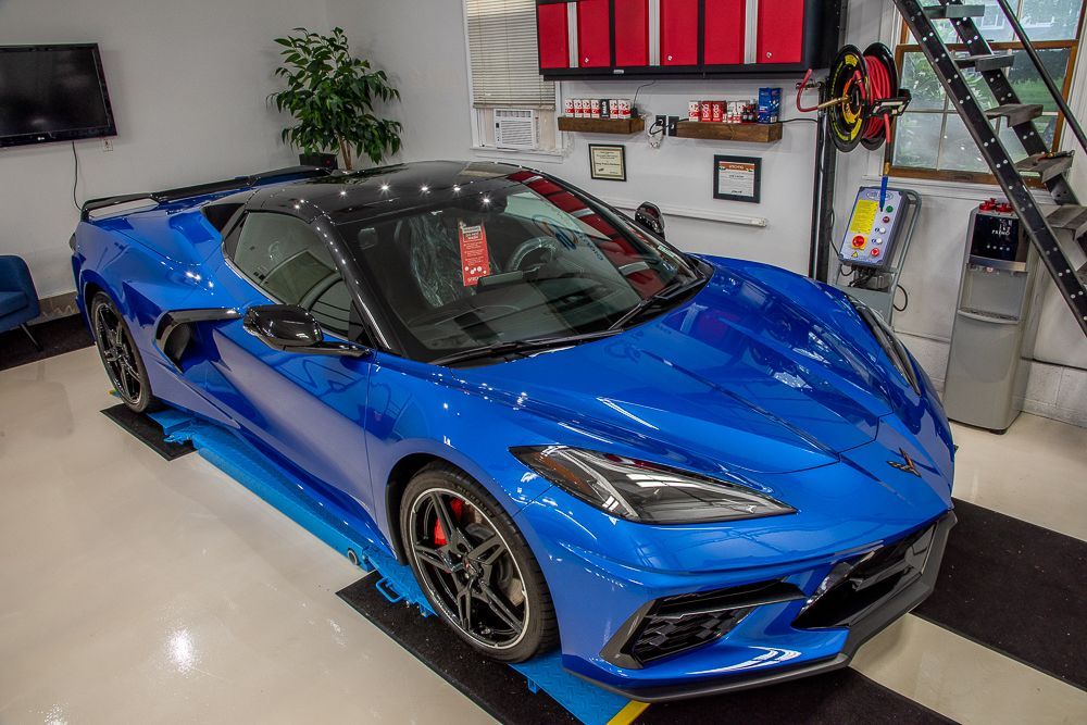 Blue sports car parked in a garage.