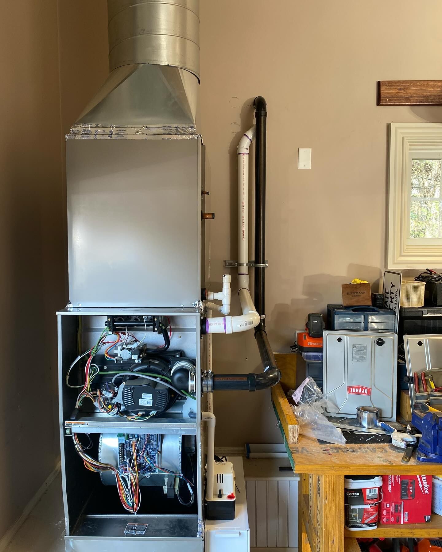 A heating system is being repaired in a garage.