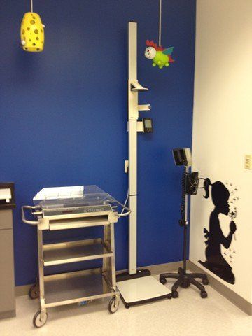 blue wall with girl blowing on flower