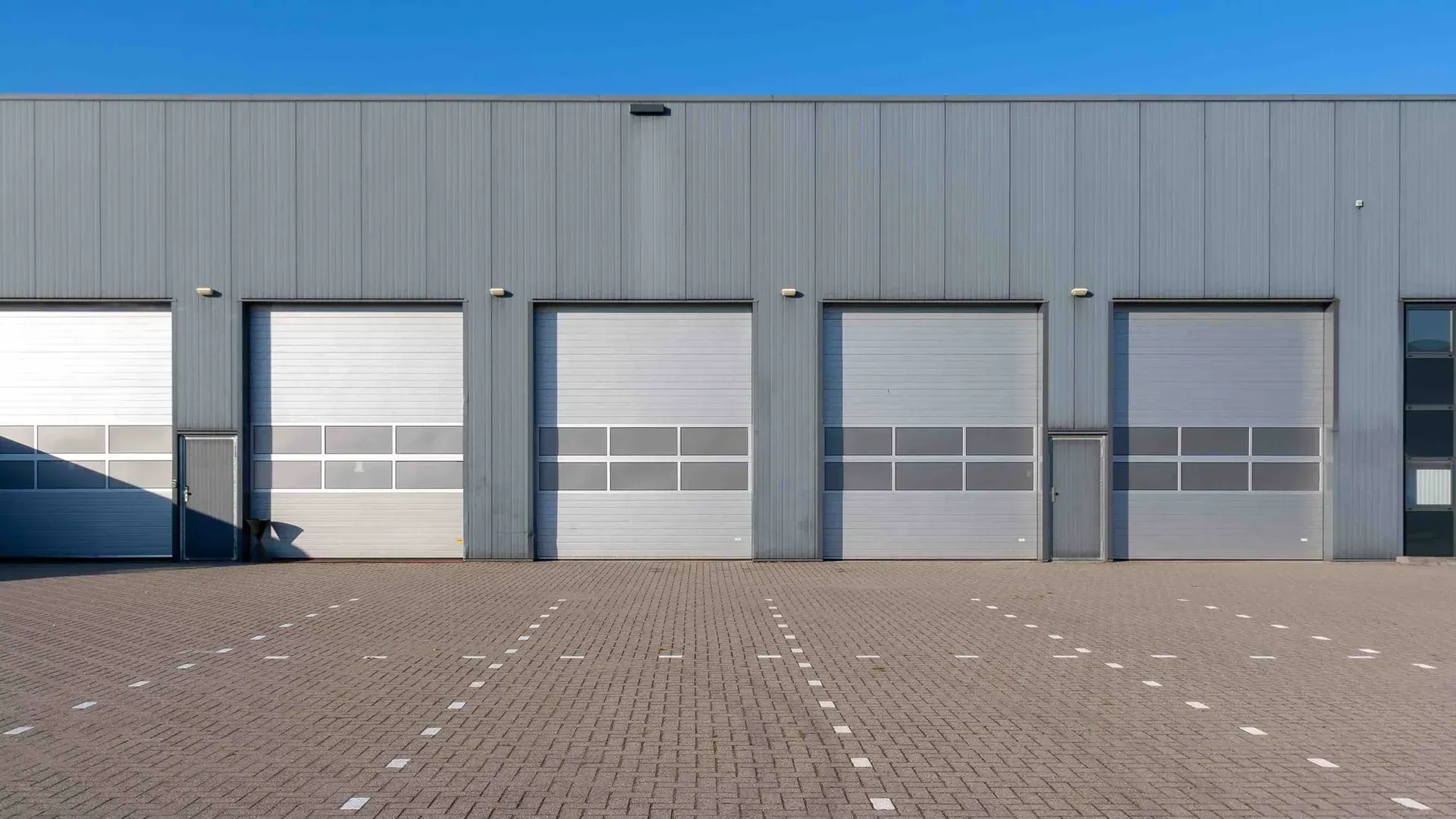 A row of garage doors on the side of a building.