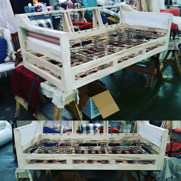 A wooden frame of a couch sitting on a table