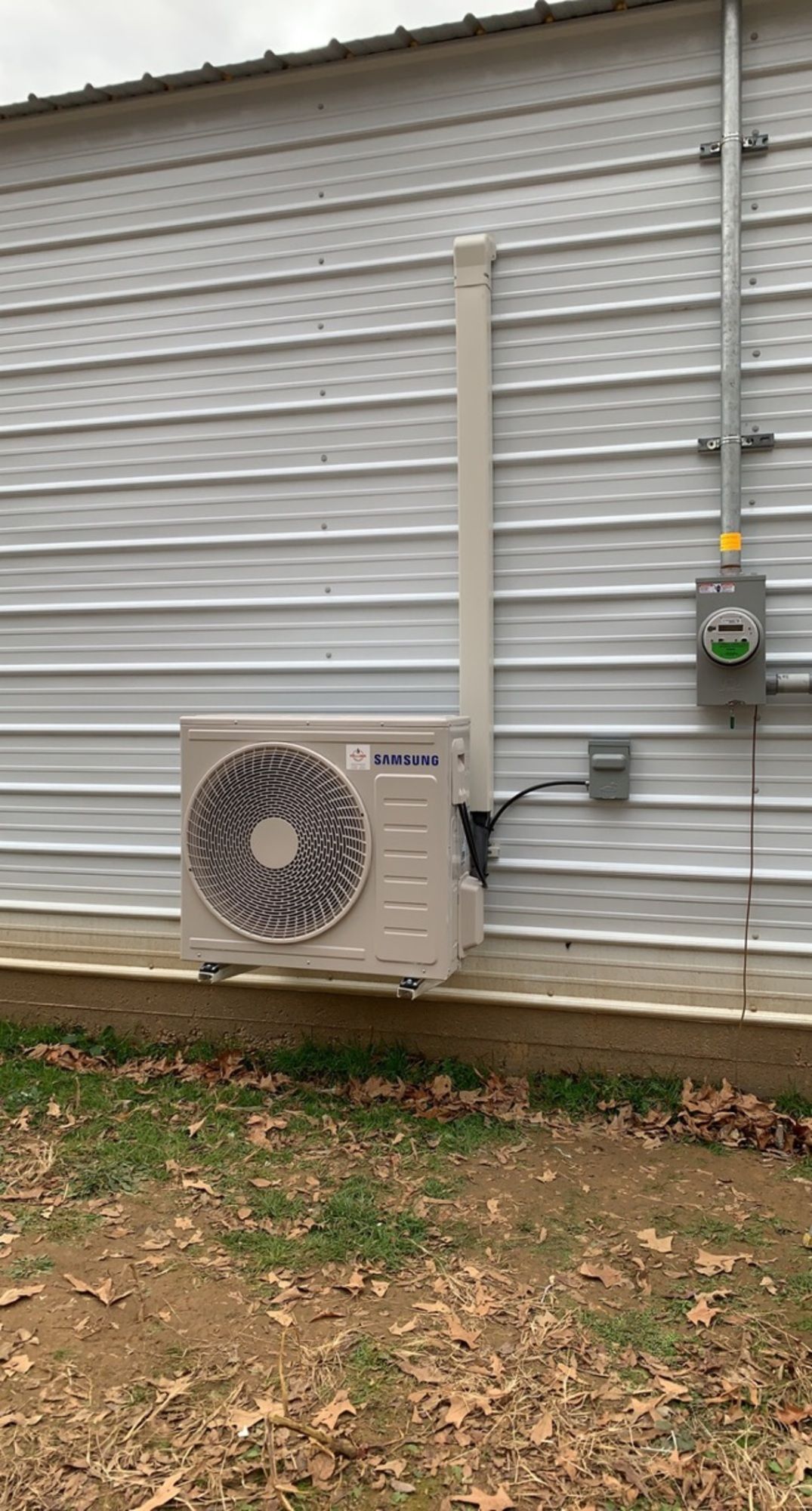 A large air conditioner is mounted on the side of a building.