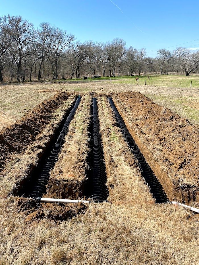 A septic system is being installed in a field.