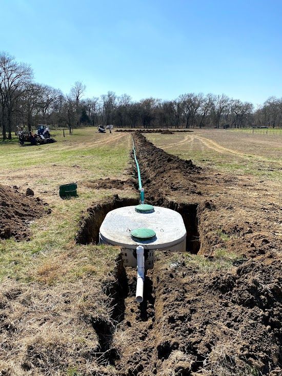 A septic tank is being installed in a field.