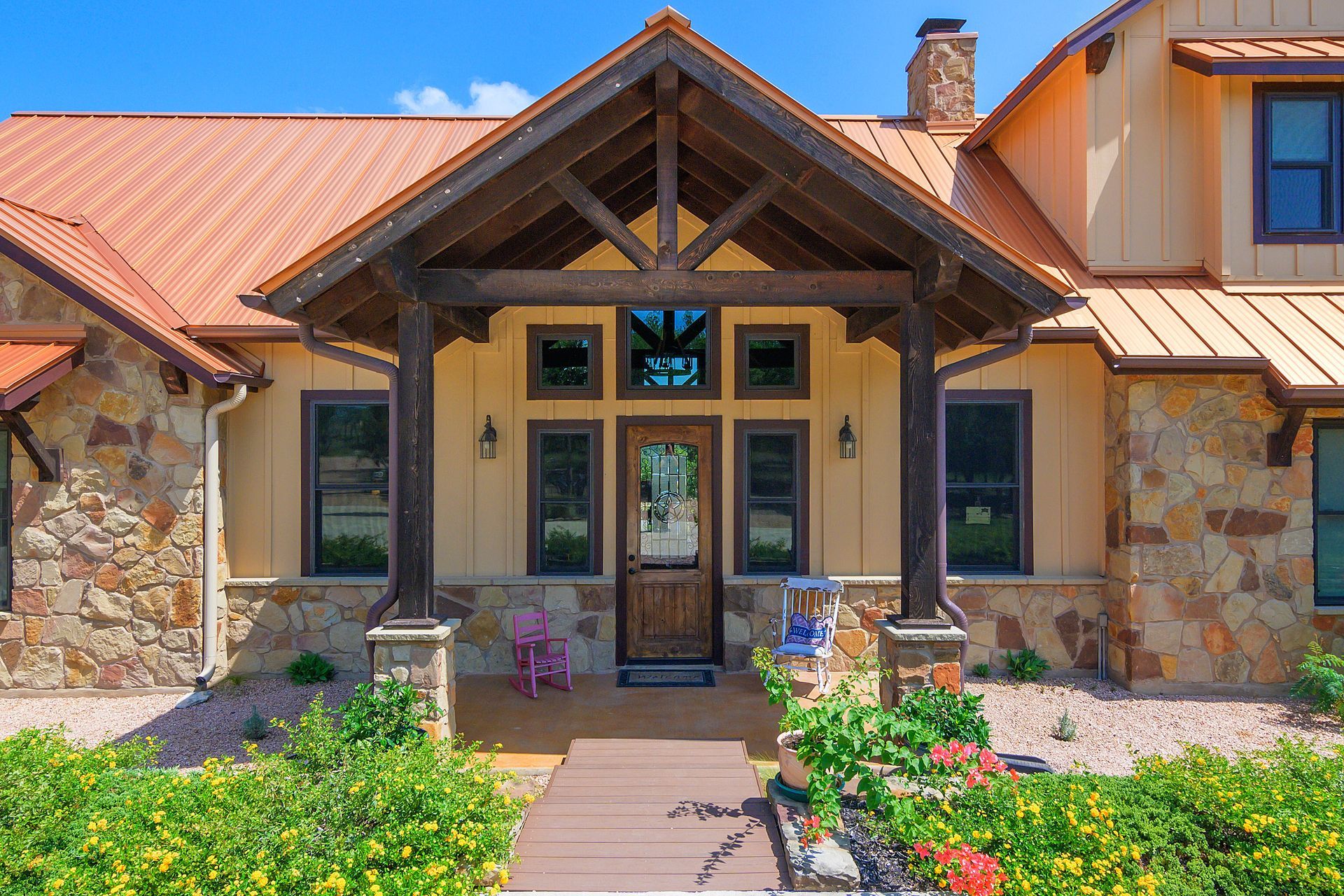 A large house with a red roof and a wooden porch