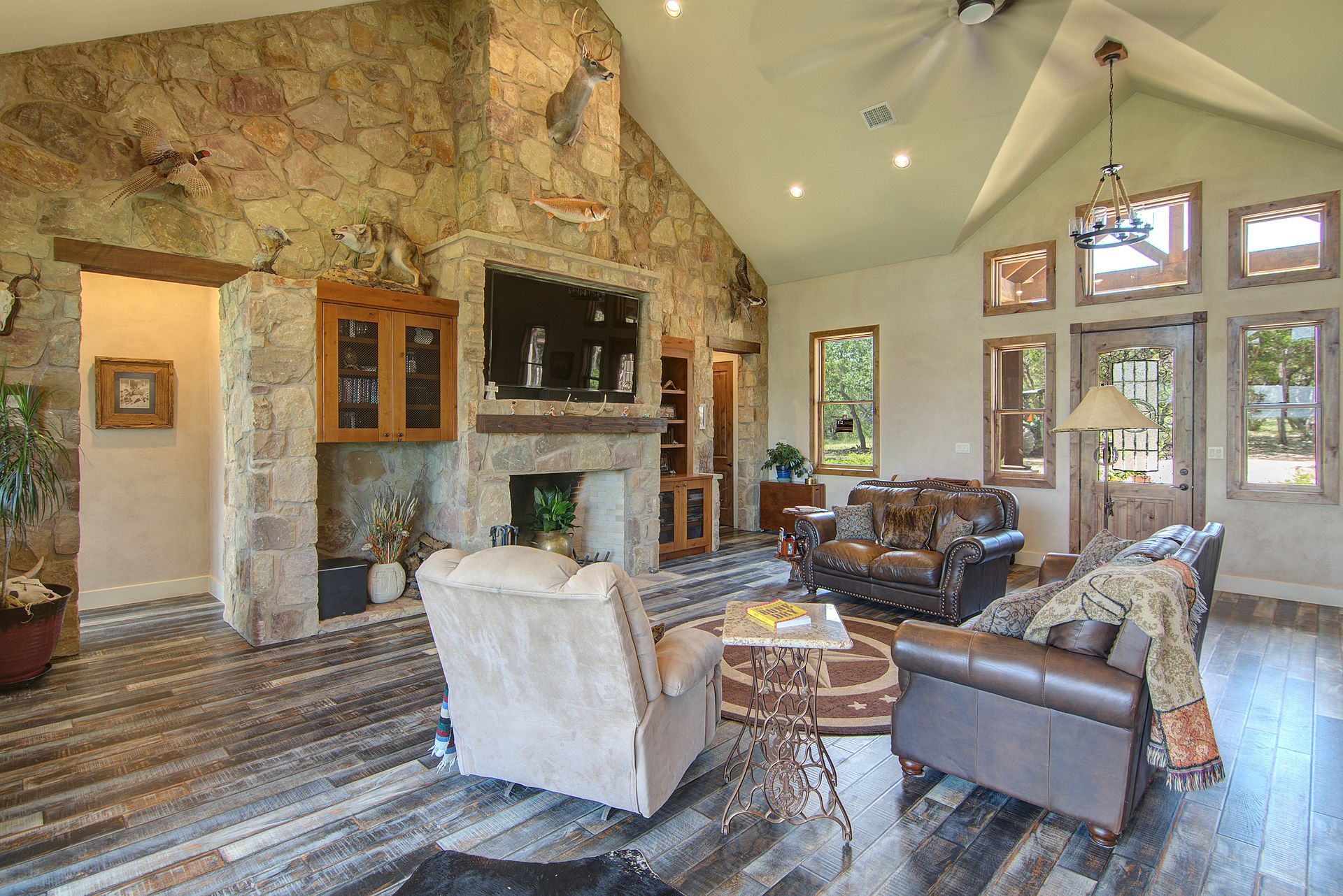 A living room with a vaulted ceiling and a fireplace