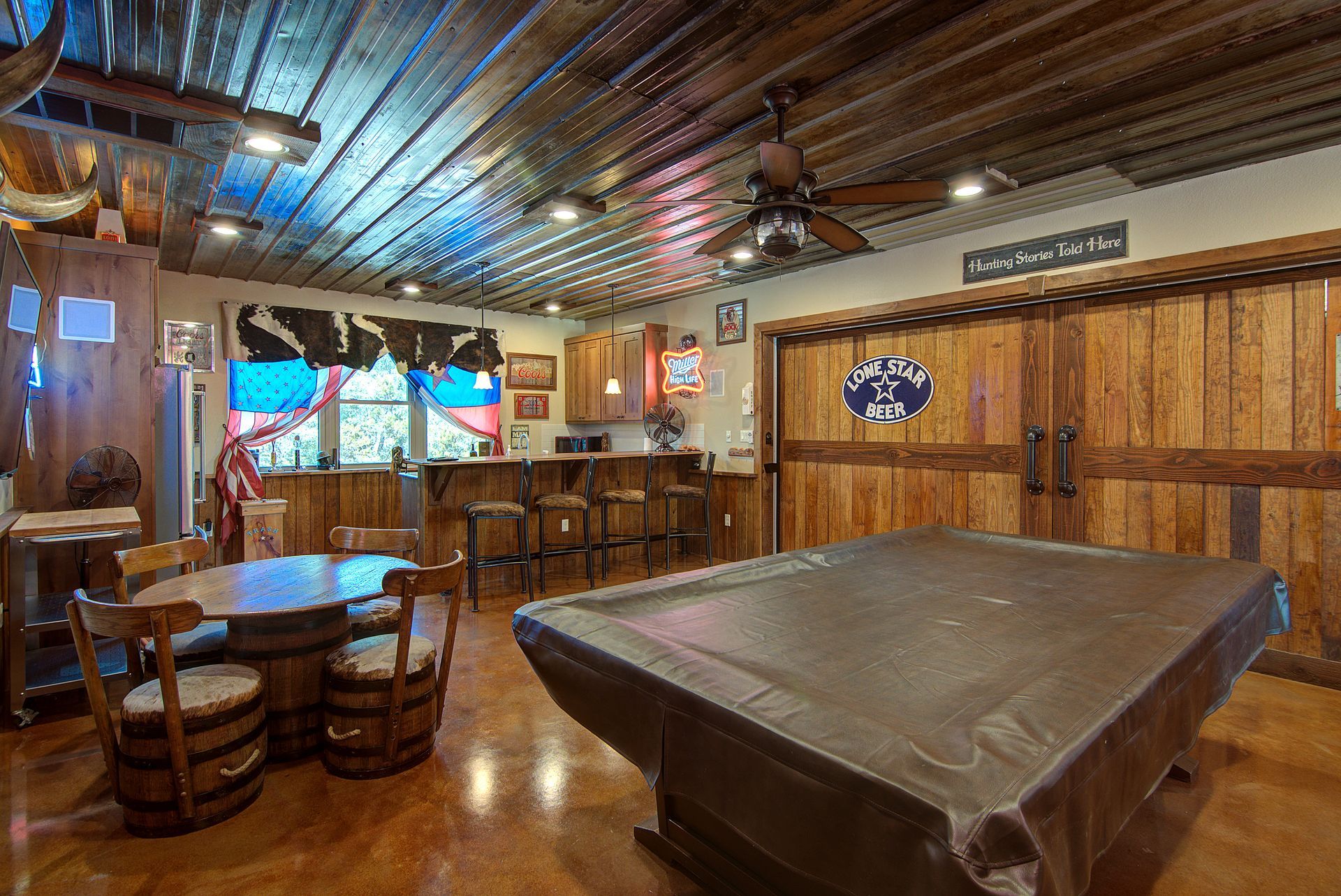 There is a pool table in the middle of the room.