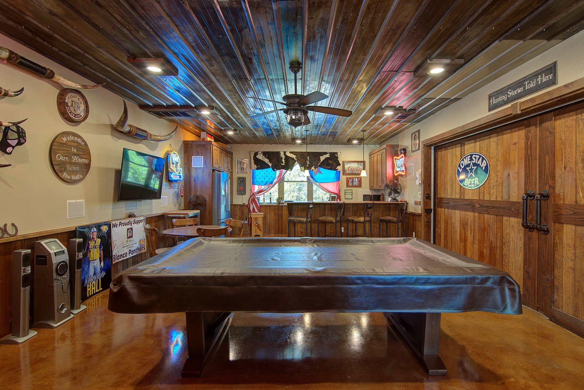 There is a pool table in the middle of the room.