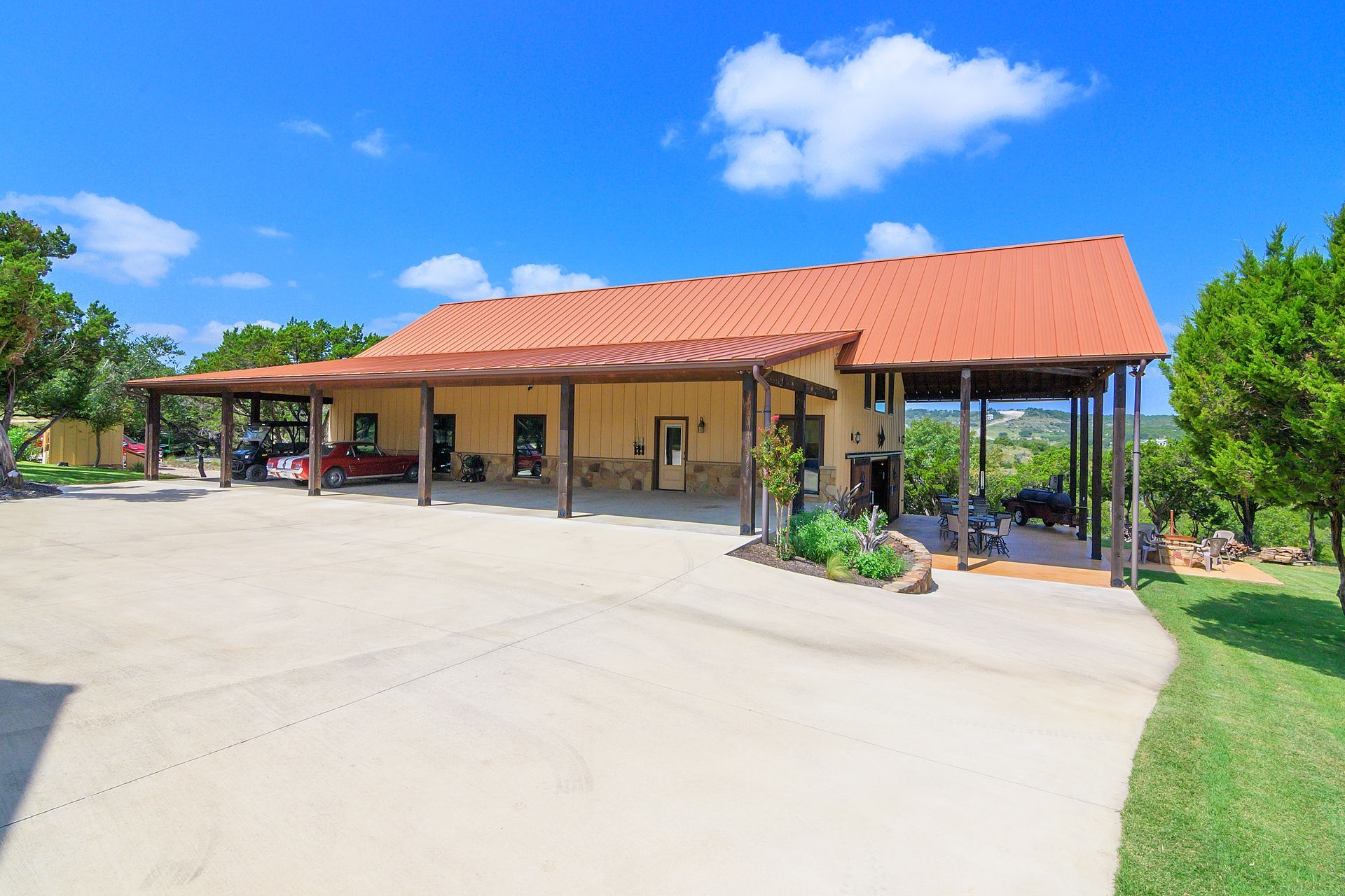 A large house with a red roof and a car parked in front of it.