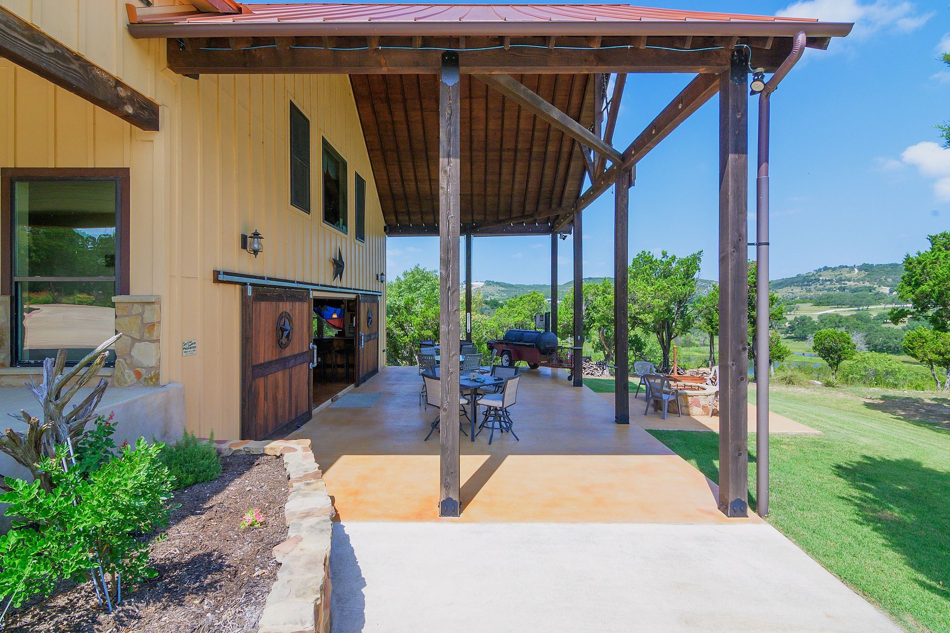 A large house with a covered porch and a sliding barn door
