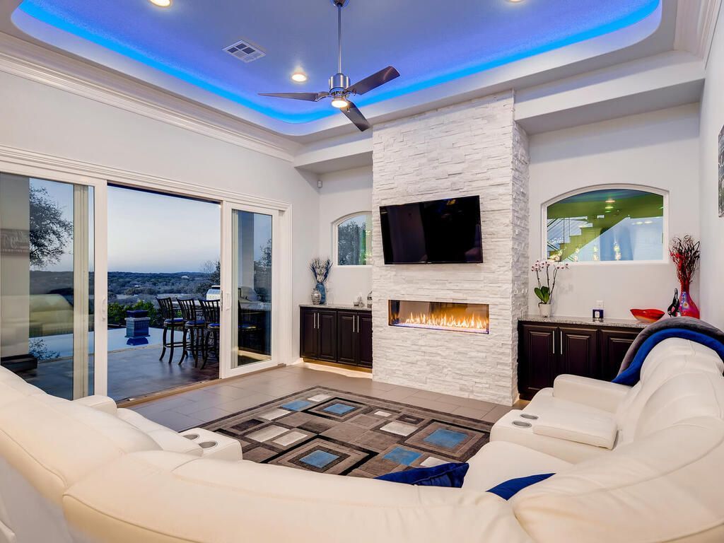 A living room with a fireplace and a flat screen tv.