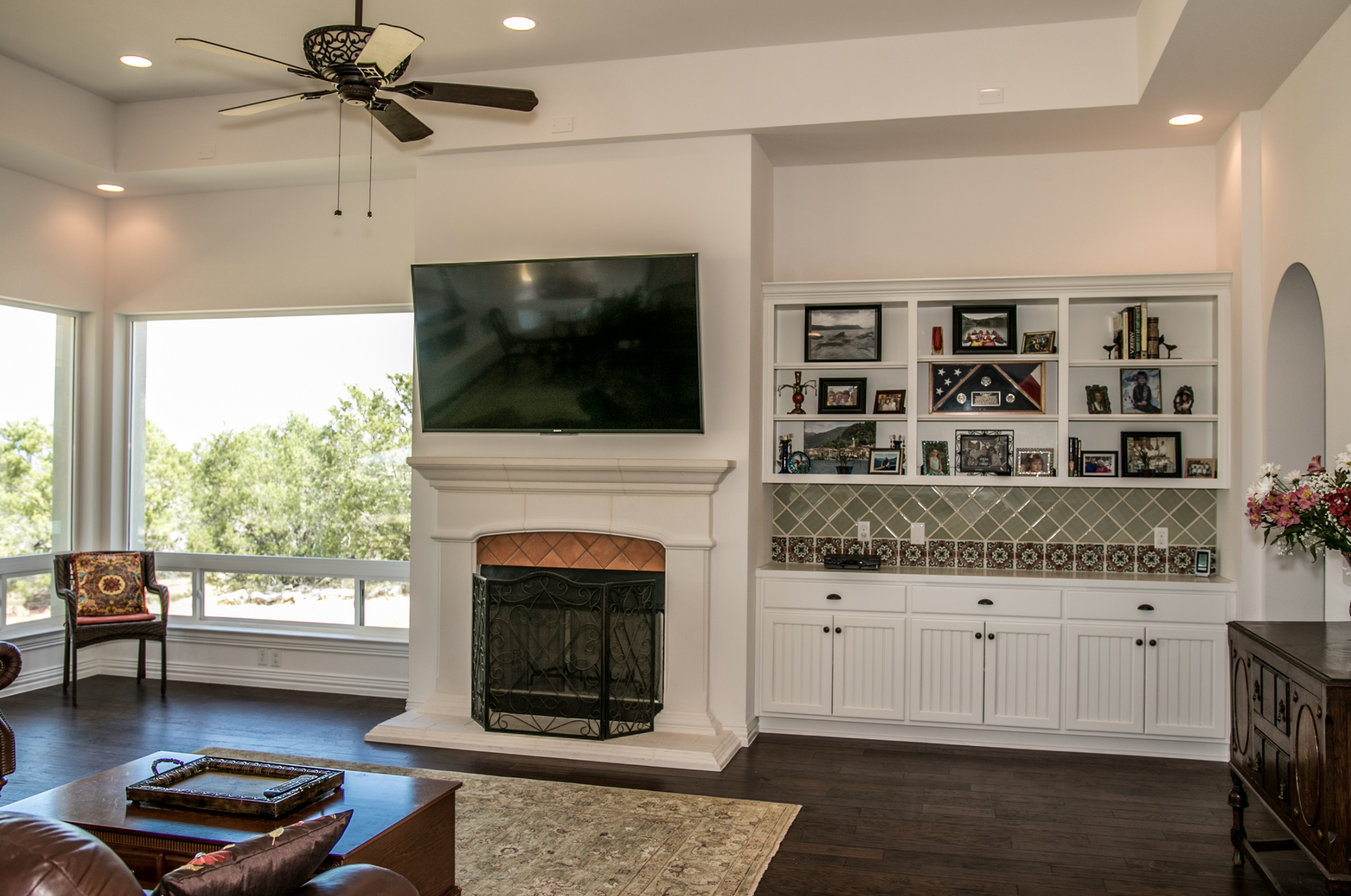 A living room with a fireplace and a flat screen tv