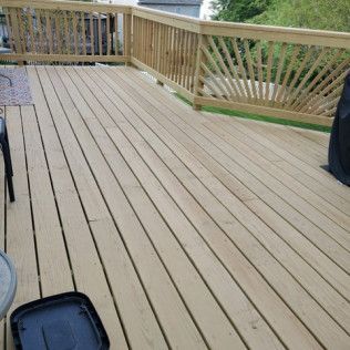 Wooden deck with a railing.