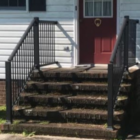 Brick steps leading to a red door with black railing.