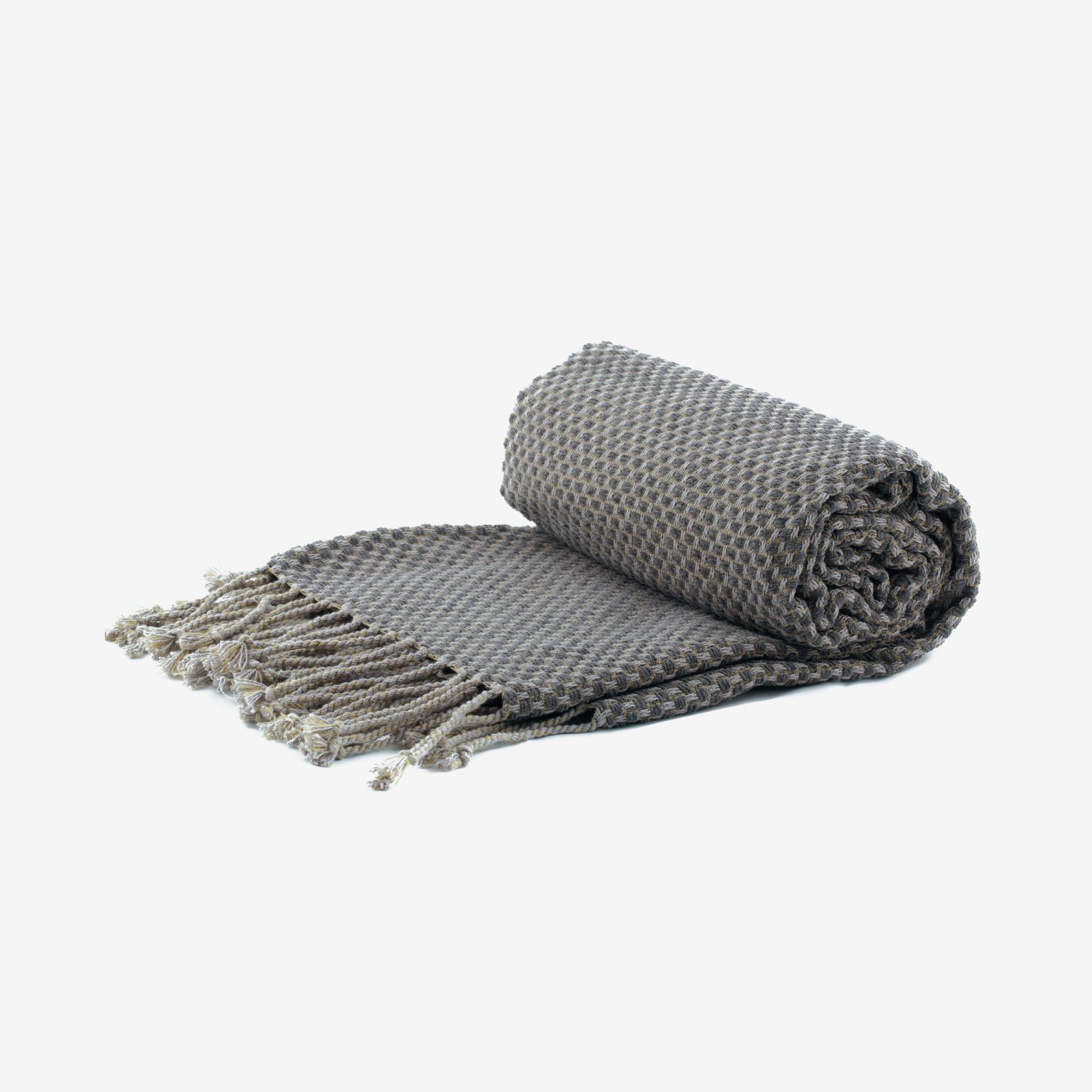 A gray blanket with fringe is rolled up on a white background.