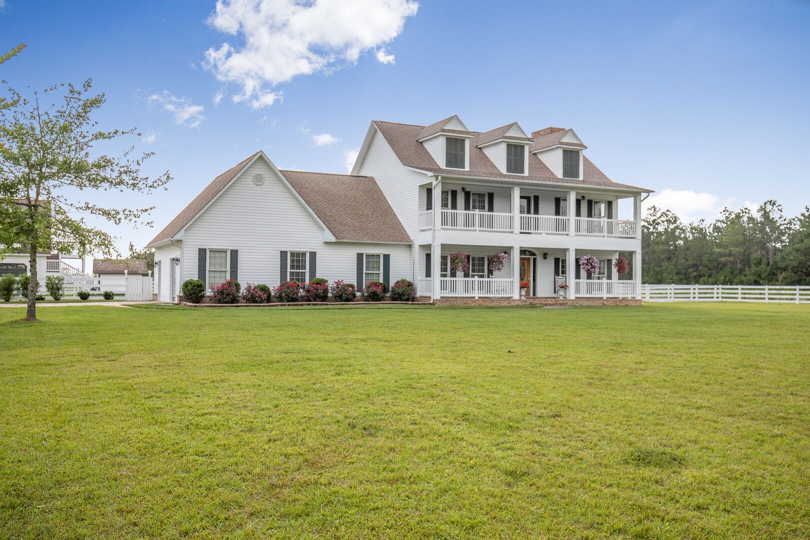 A large white house with a large porch