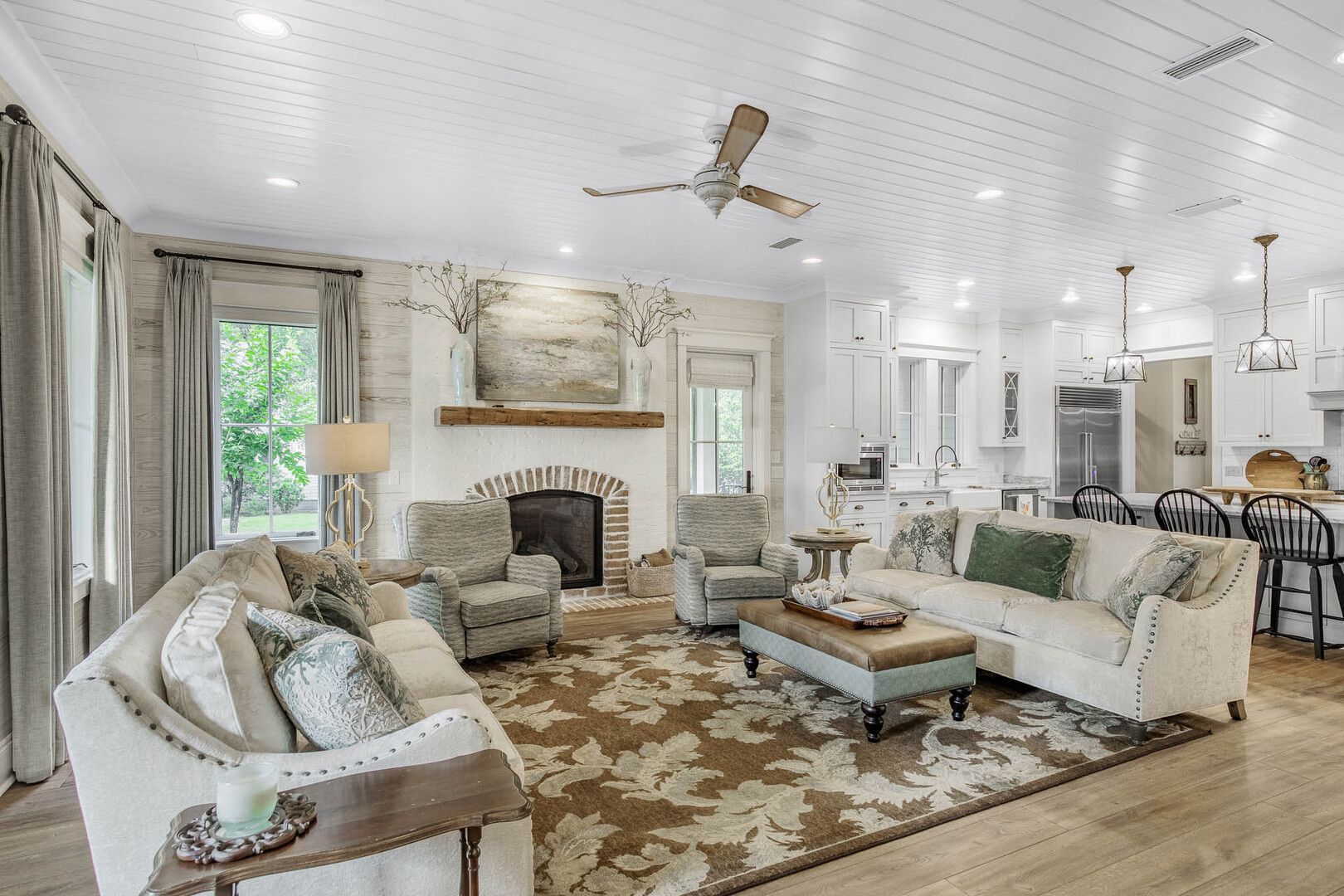 A living room with a fireplace and a ceiling fan