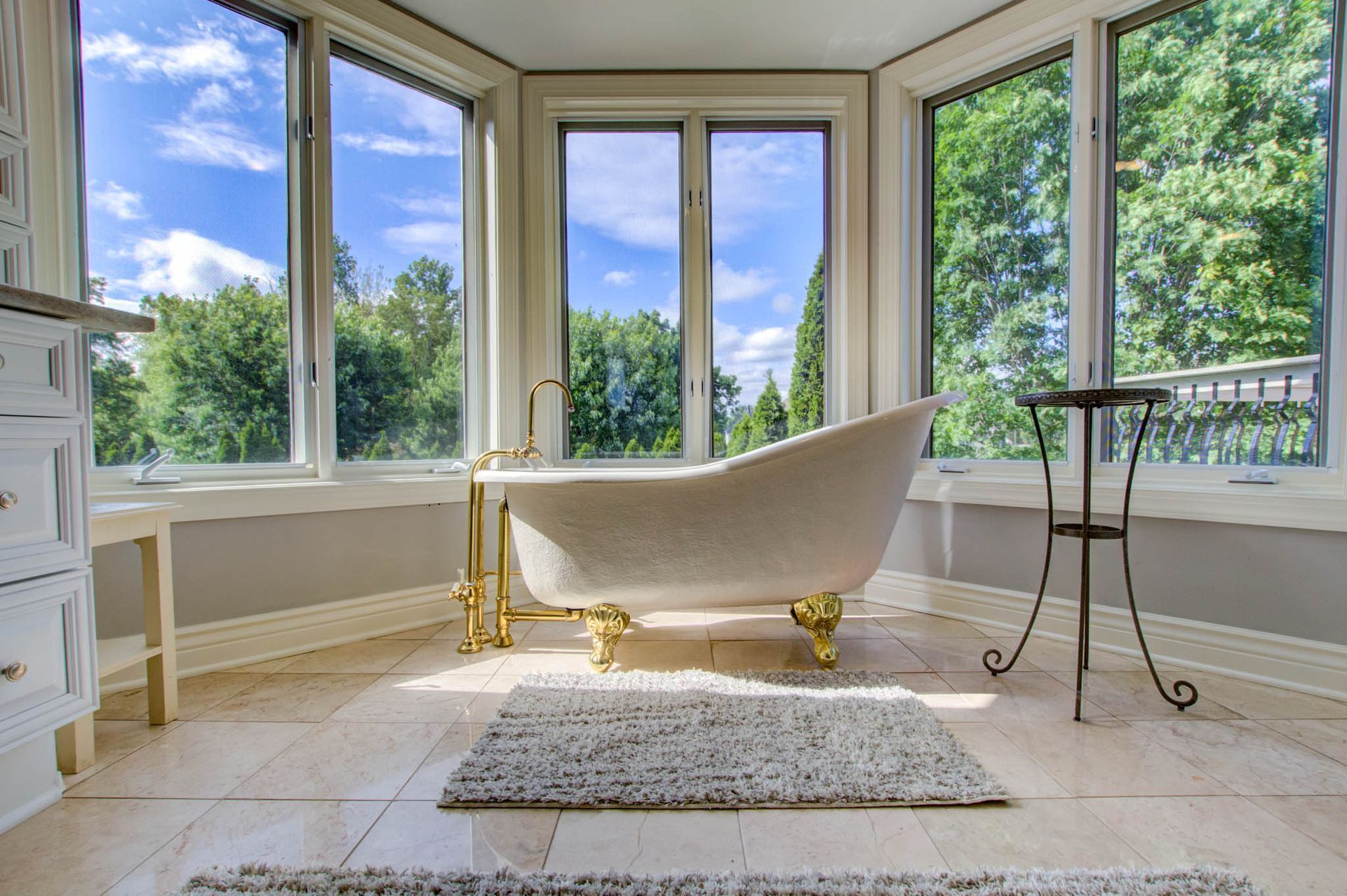 A bathtub in a bathroom with a lot of windows