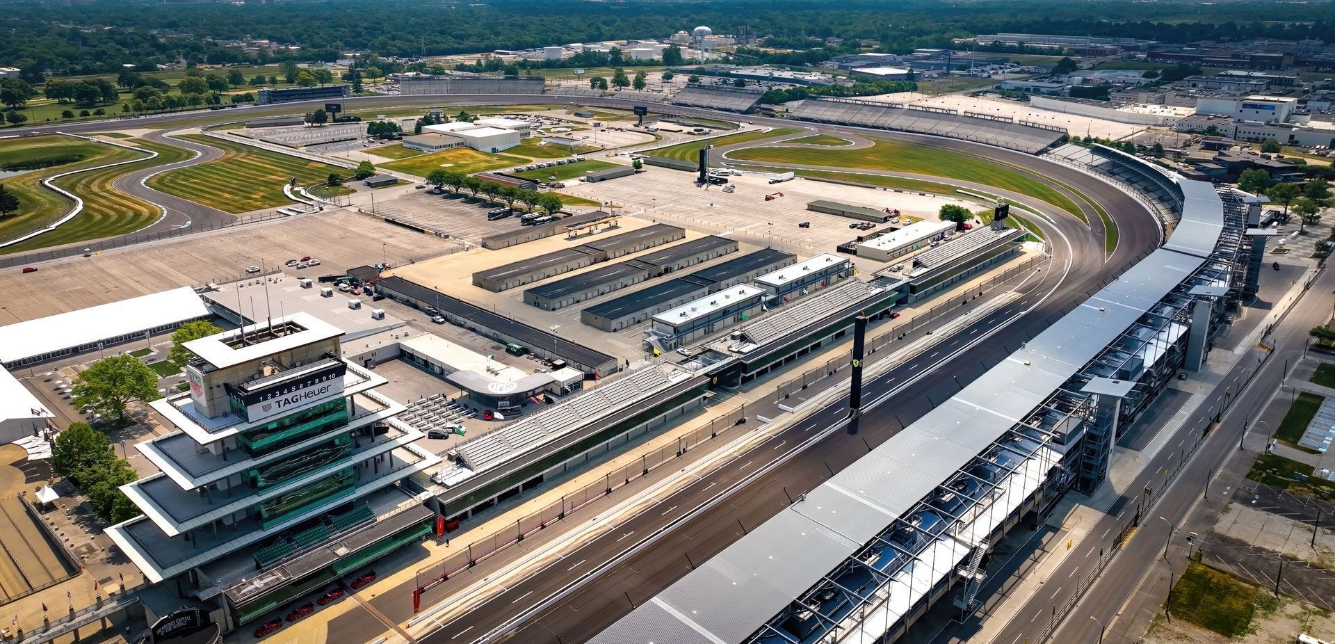 An aerial view of a race track with a lot of cars on it .