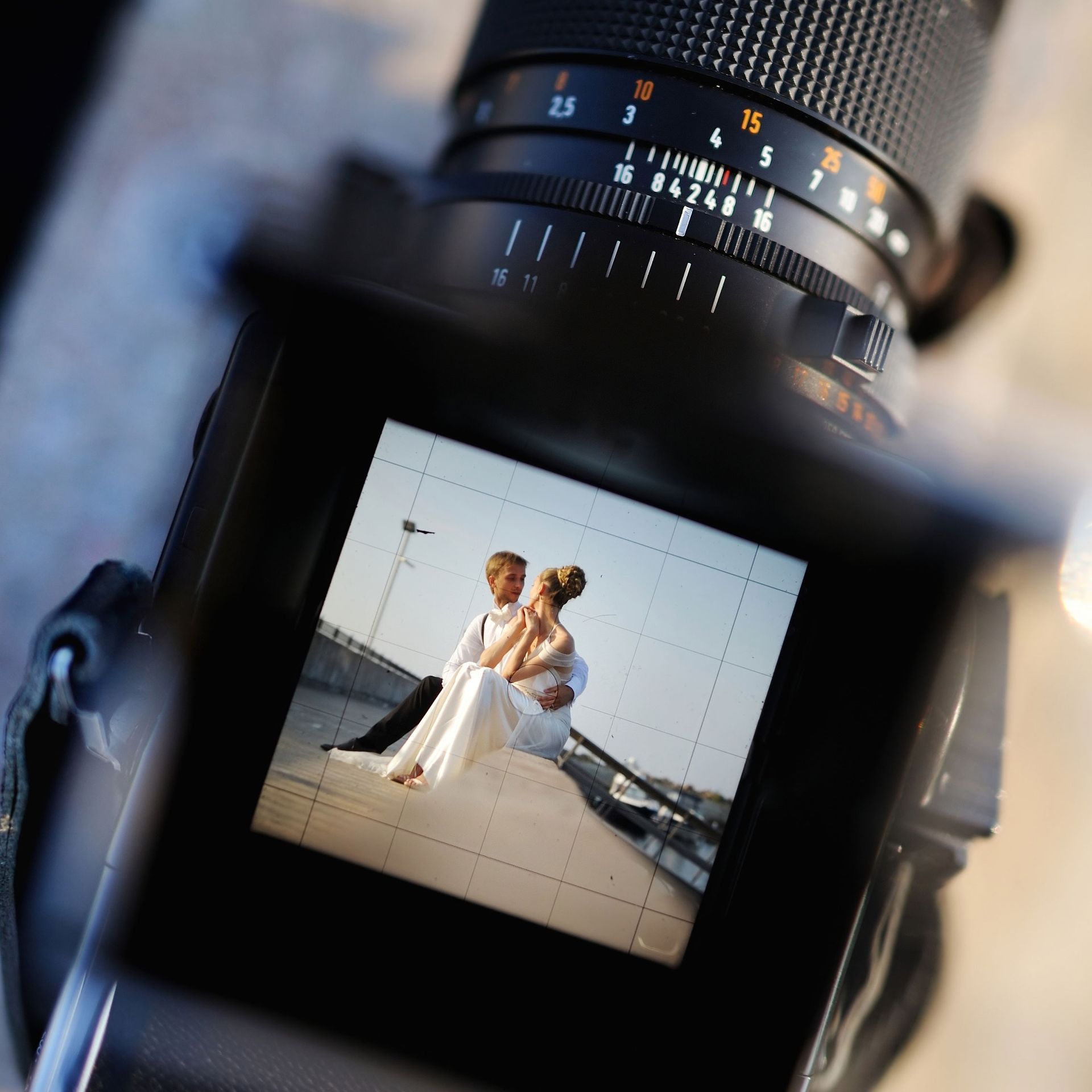 A picture of a bride and groom on the screen of a camera