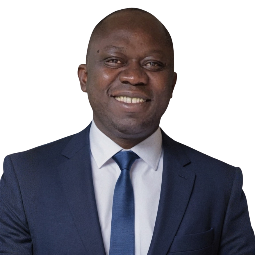 Smiling man in a navy suit, white shirt, and blue tie against a white background