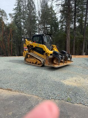 A yellow excavator is digging a hole in the dirt on a construction site.