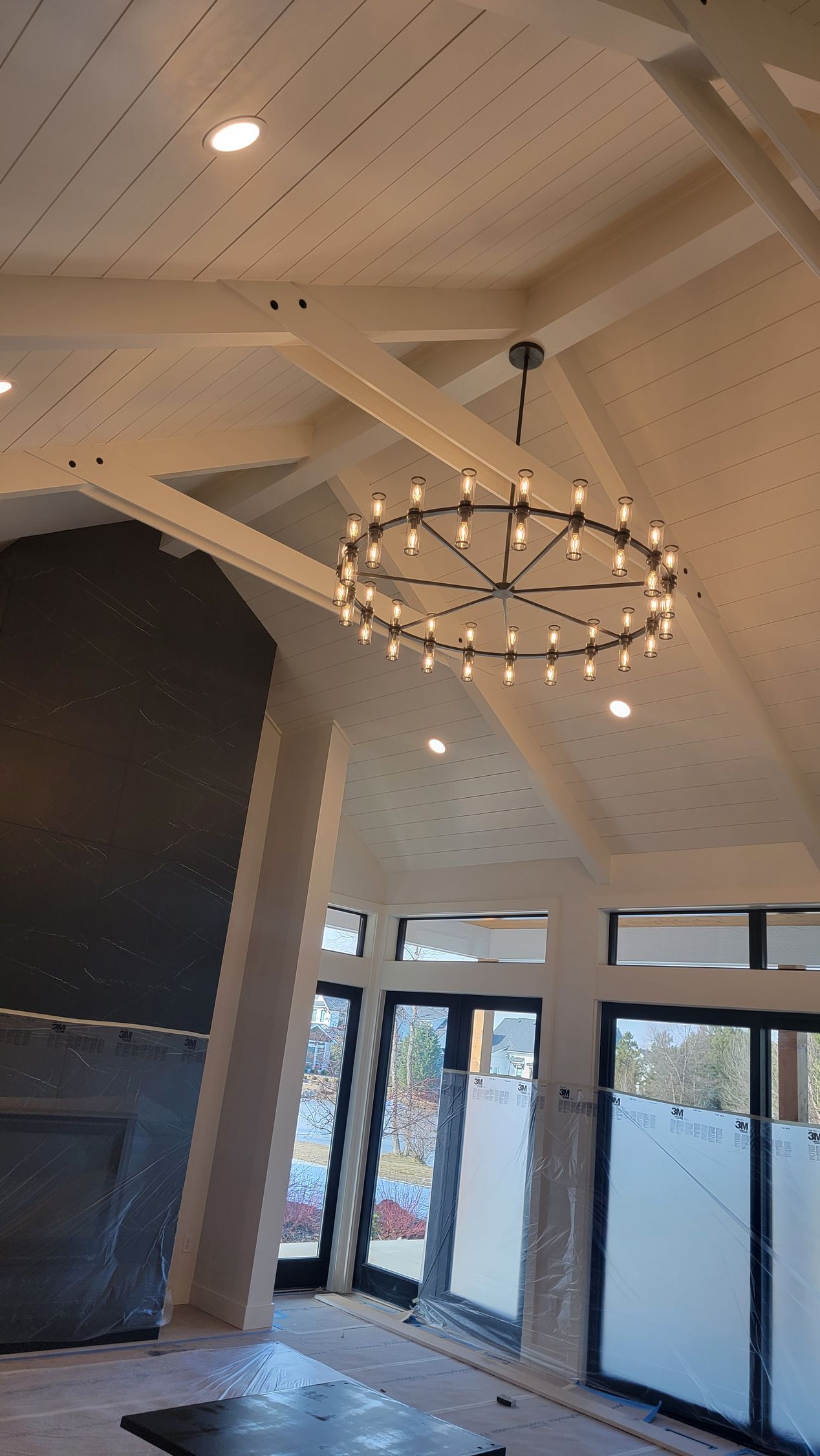 A large chandelier is hanging from the ceiling of a room.