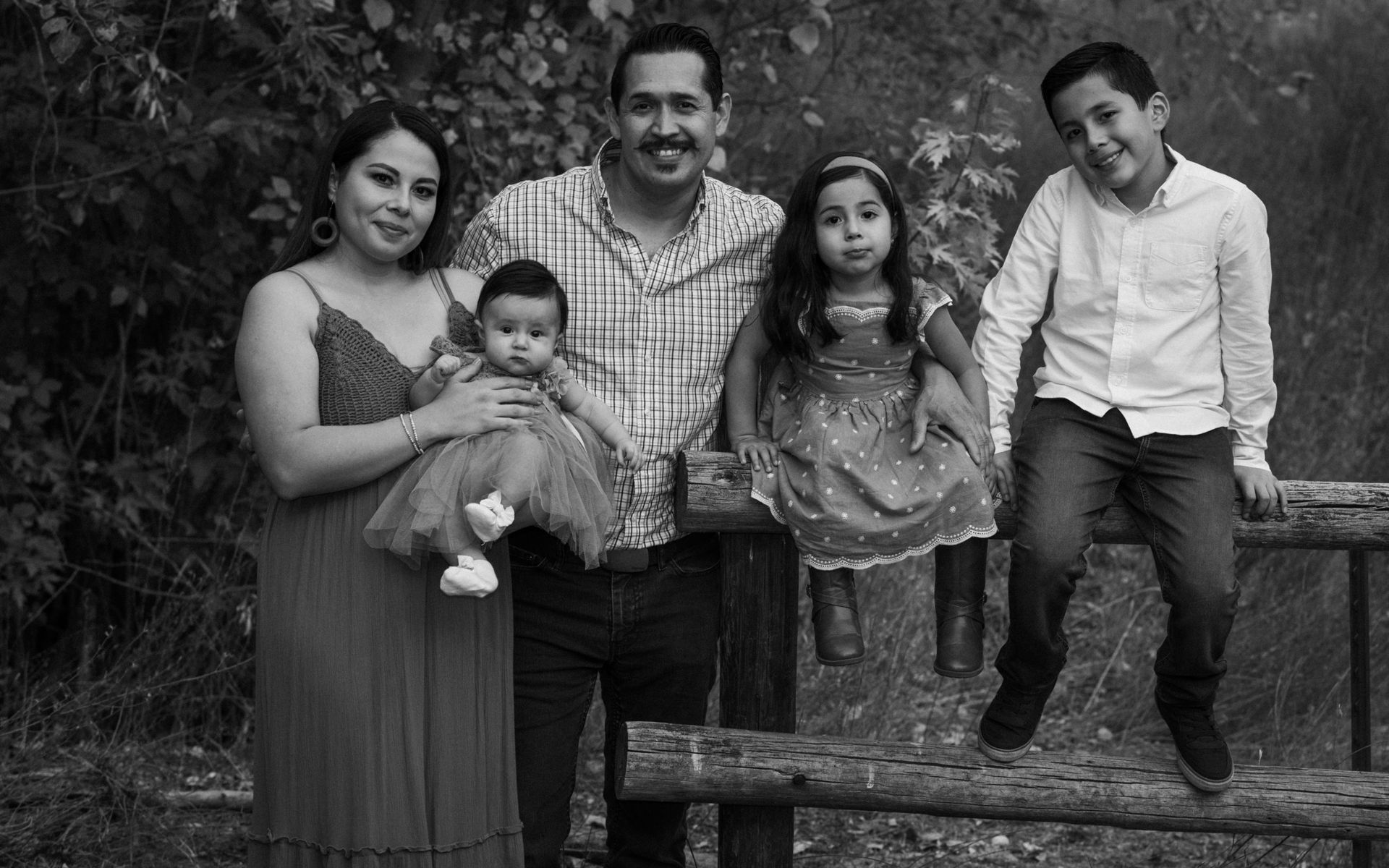 A black and white photo of a family posing for a picture.