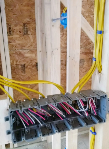 A construction worker is working on a wall in a building under construction.