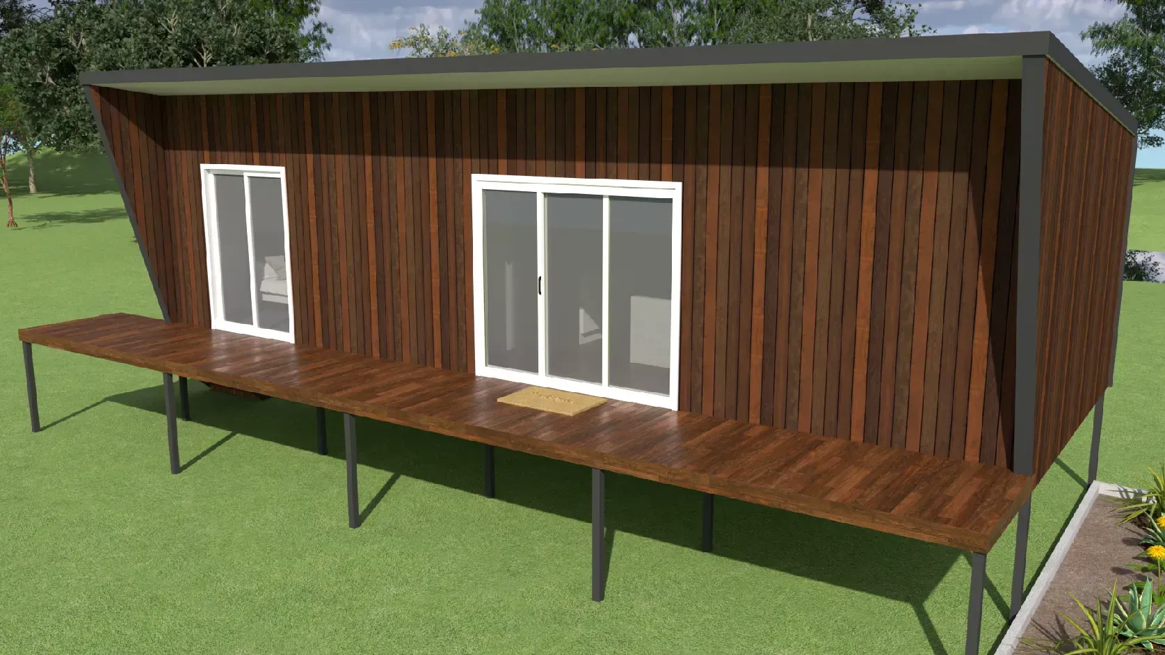 Modern brown cabin with a deck, sliding glass doors, and a sloping roof on a grassy lawn.