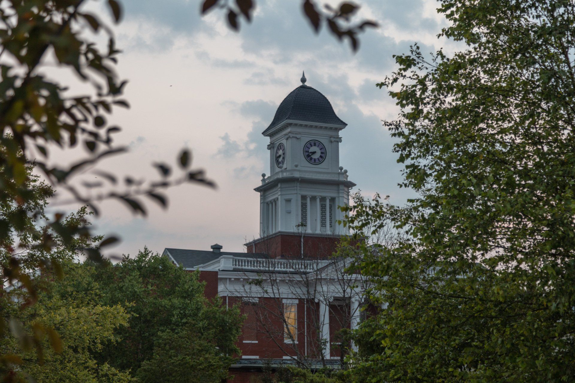 A large brick building with a clock tower surrounded by trees – Jonesborough, TN - Law Offices of James R Wheeler