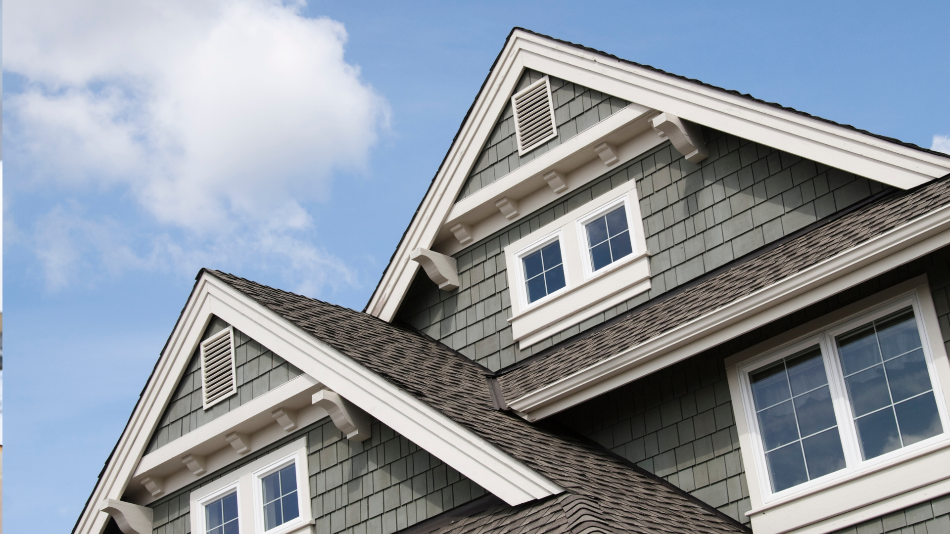 The roof of a house with a blue sky in the background.