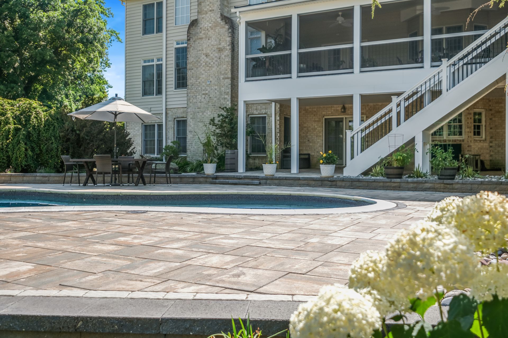A large house with a large swimming pool in front of it.