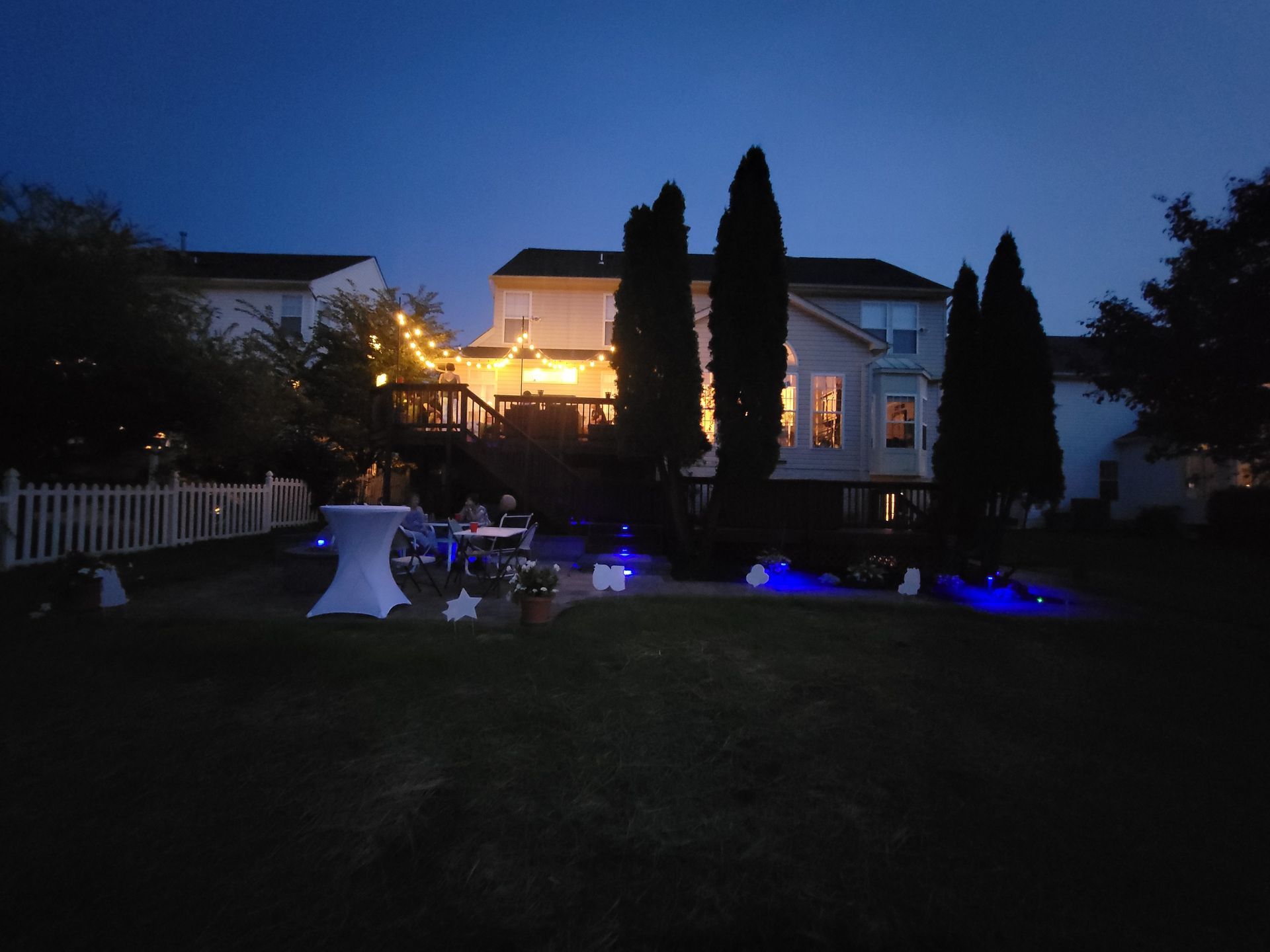 Outdoor lighting installation by Bayside Outdoor Living illuminating a patio and deck for ambiance and safety.