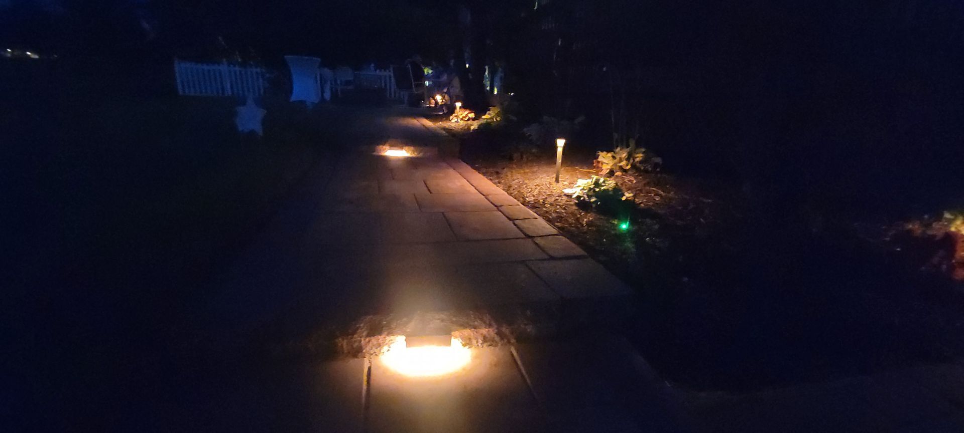 There is a fire pit in the middle of the road at night.