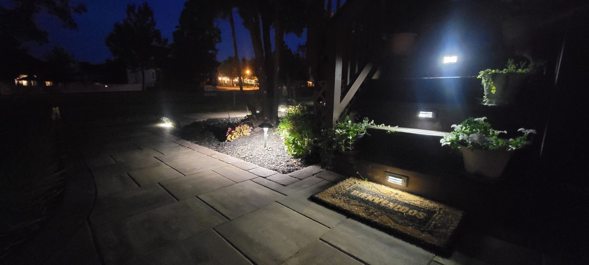An aerial view of a patio at night with lights on.