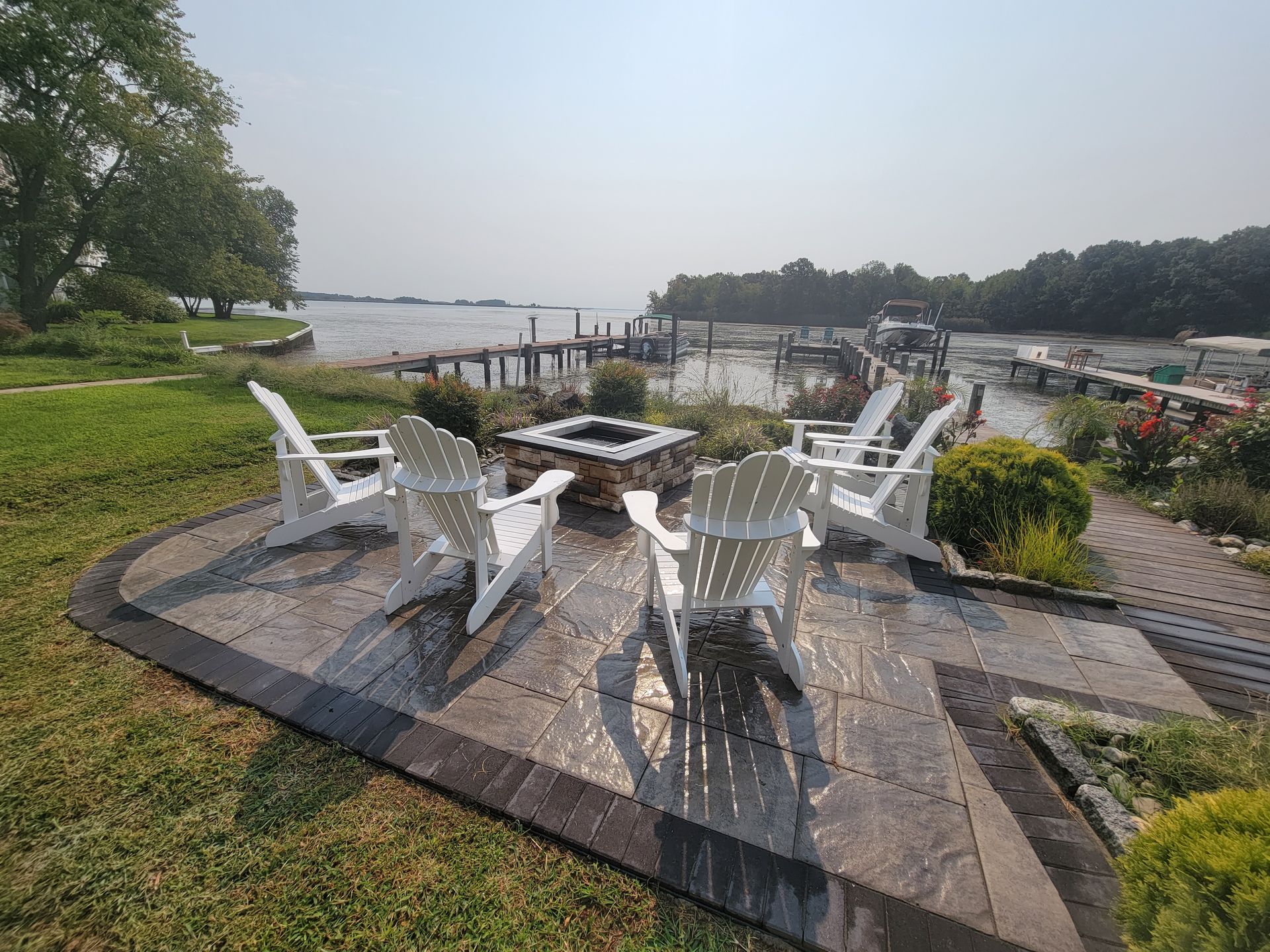 A patio with a ceiling fan and a potted plant on the counter.